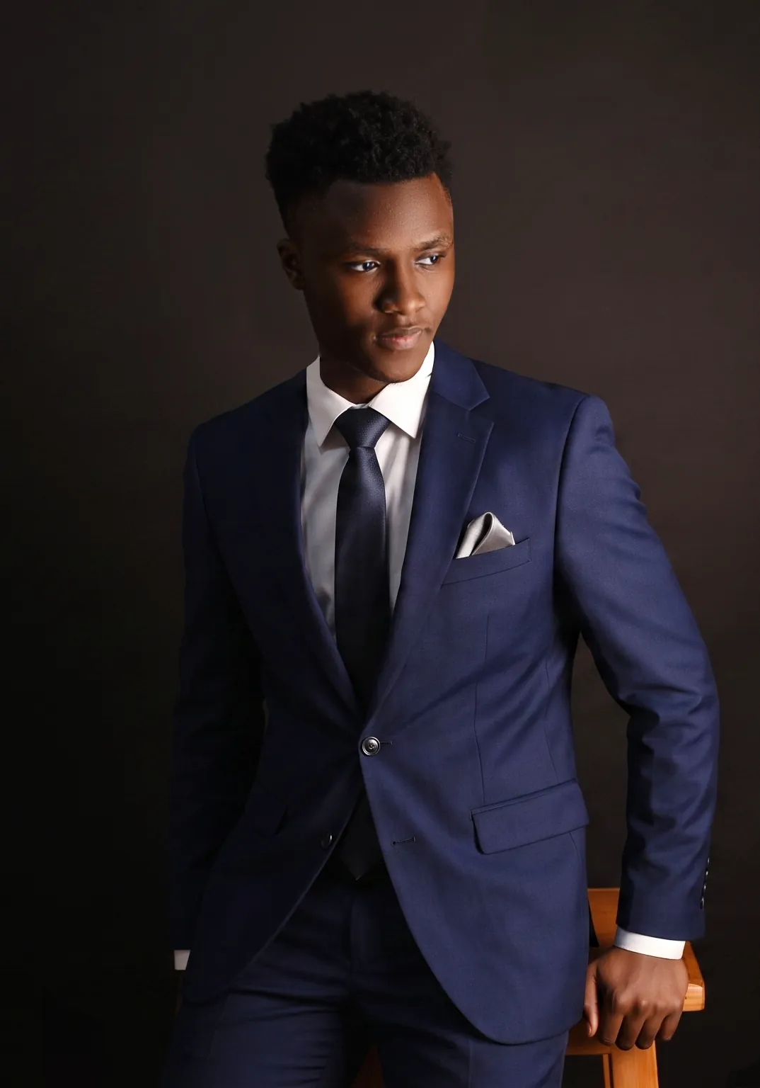 Professional portrait of a man in a navy suit